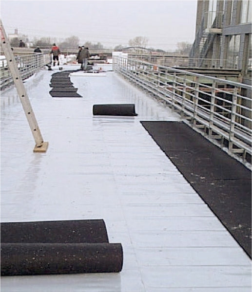 Rubber sacrificial layer mat used during construction to prevent damage to underlying surfaces.